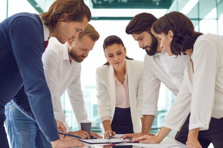 Equipo directivo revisando estrategia de comunicación post-vacaciones para aumentar visibilidad de marca B2B.
